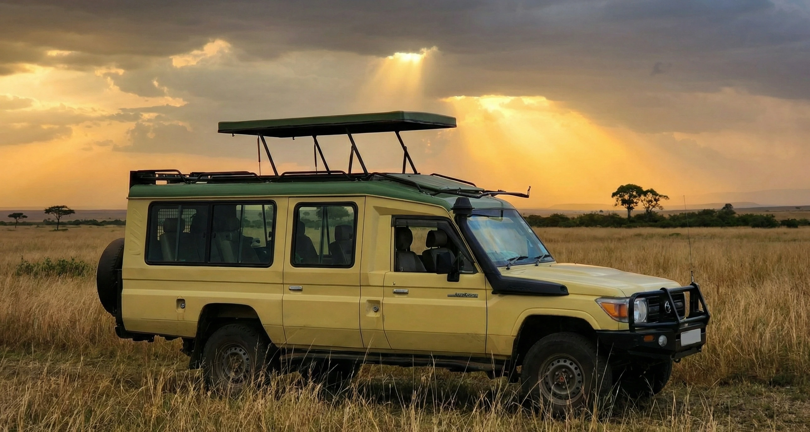 Open-roof Land Cruiser parked beside a wildlife sighting at sunset.