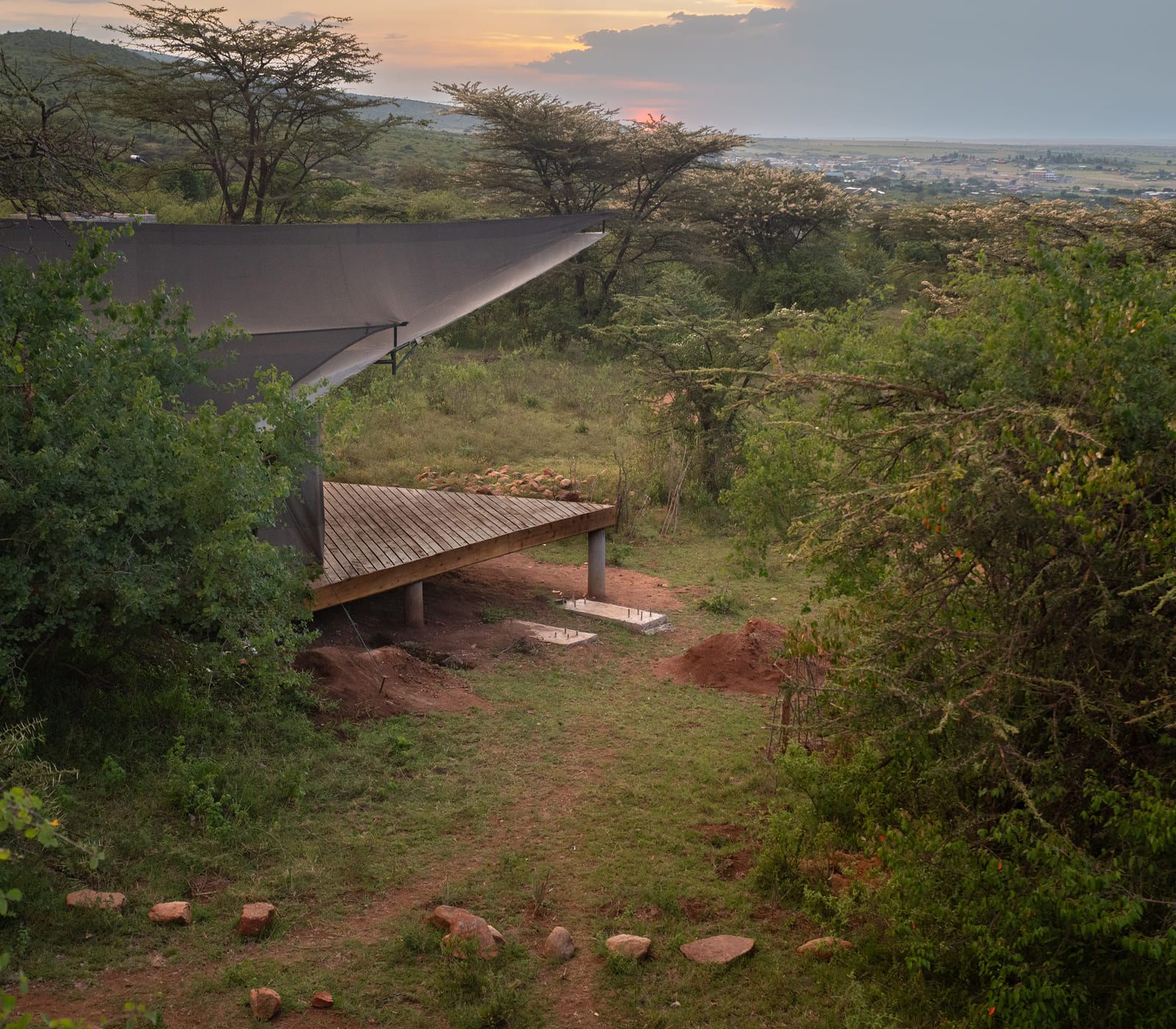 Wide shot of the Maasai Mara escarpment at golden hour.
